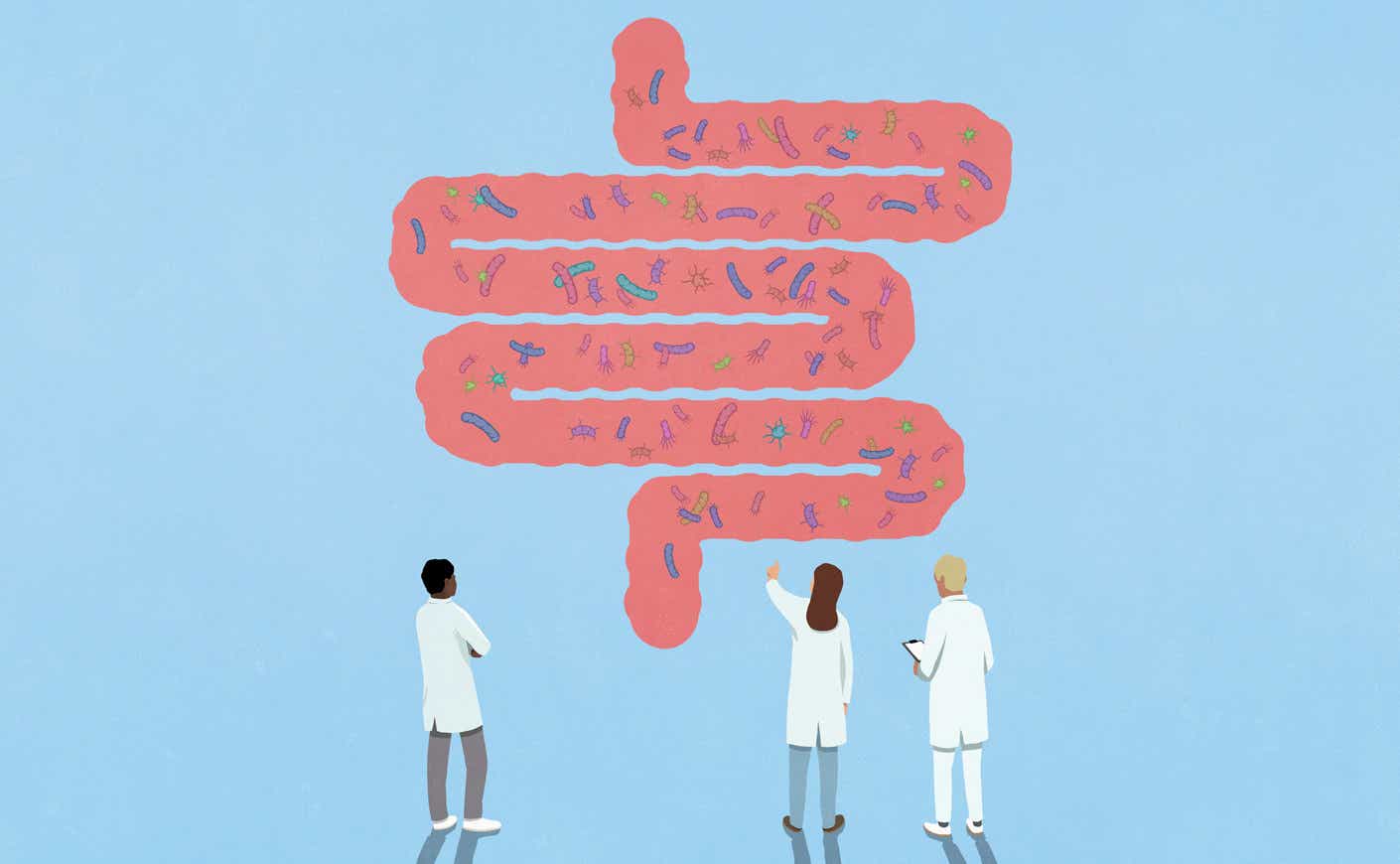doctors looking at an enlarged illustration of a colon