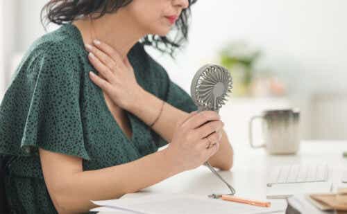 woman holding fan in office