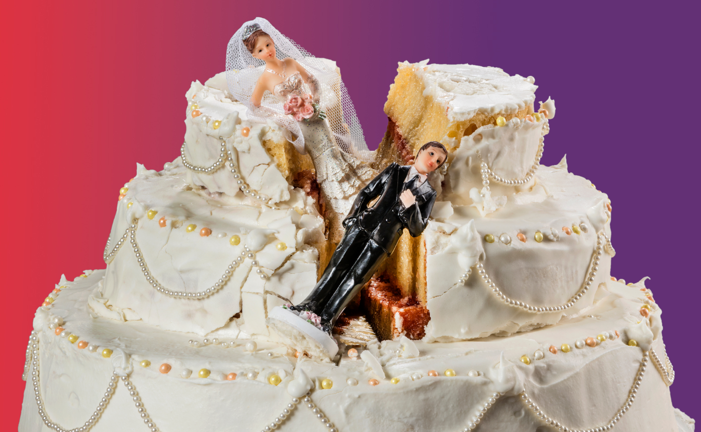 Bride and groom cake toppers falling on a ruined wedding cake