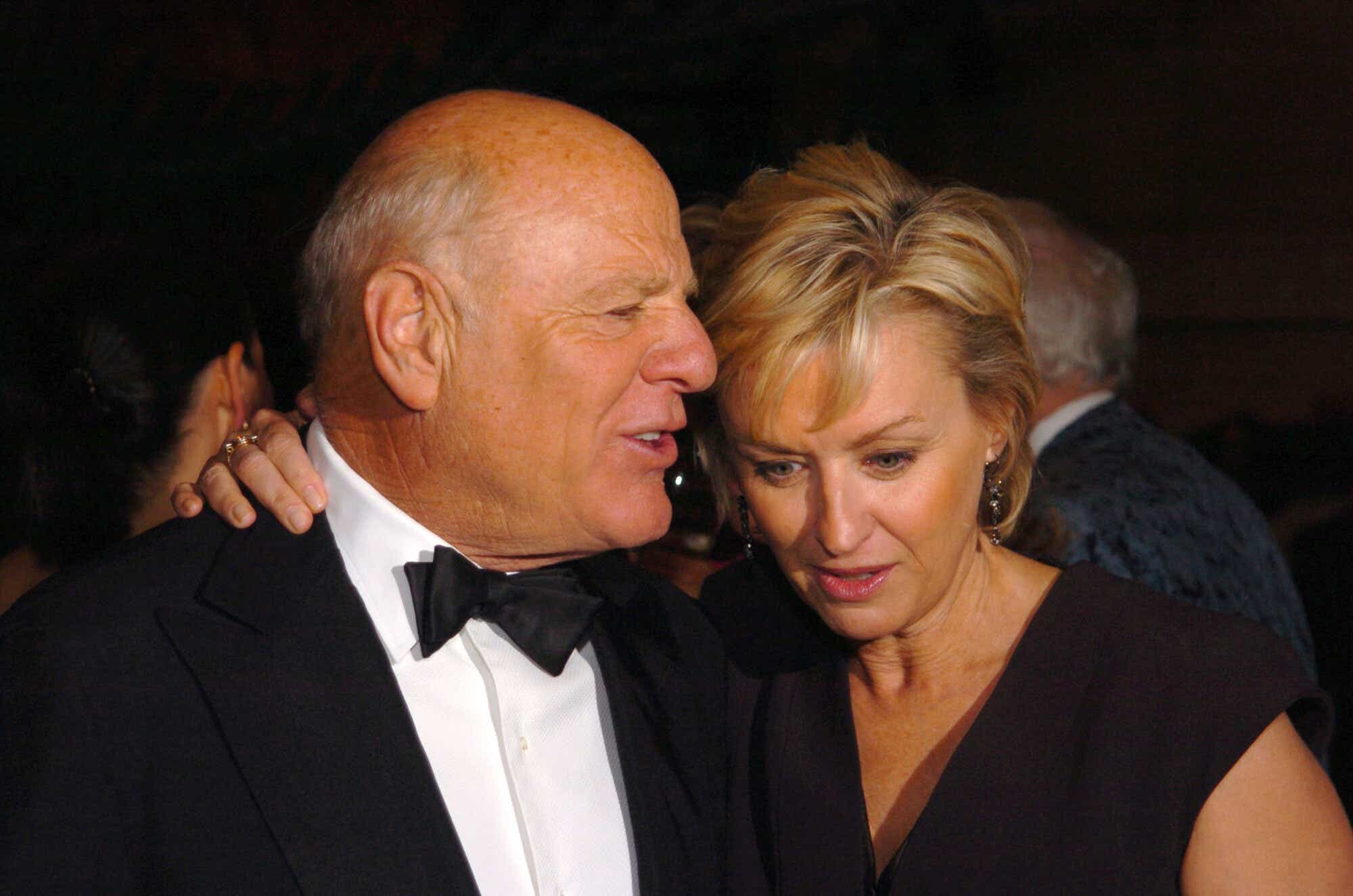 Barry Diller says something to Tina Brown, who has a hand on his shoulder.