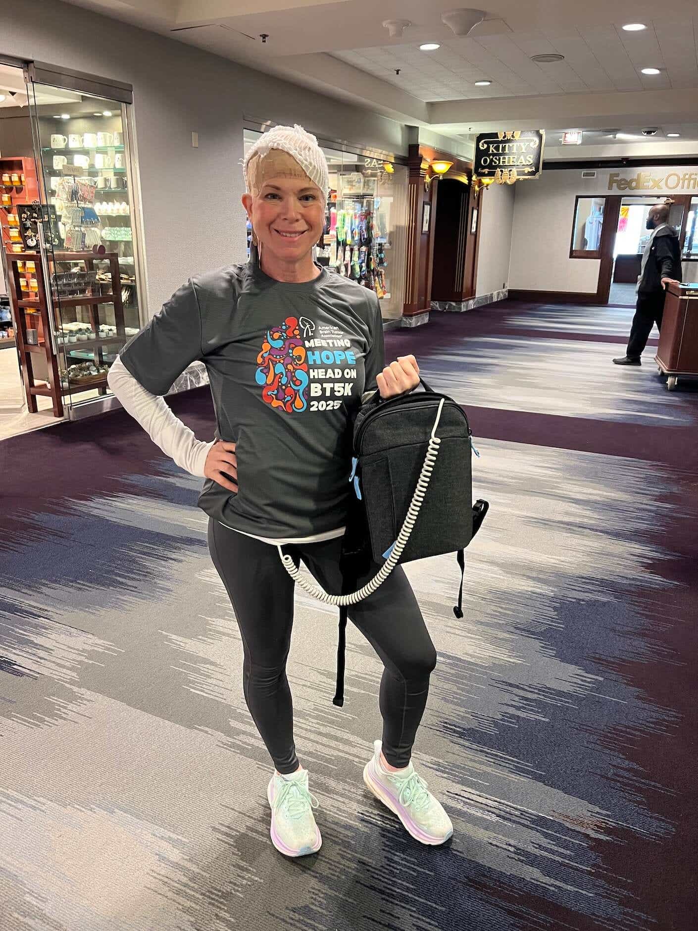 woman wearing an optune gio device