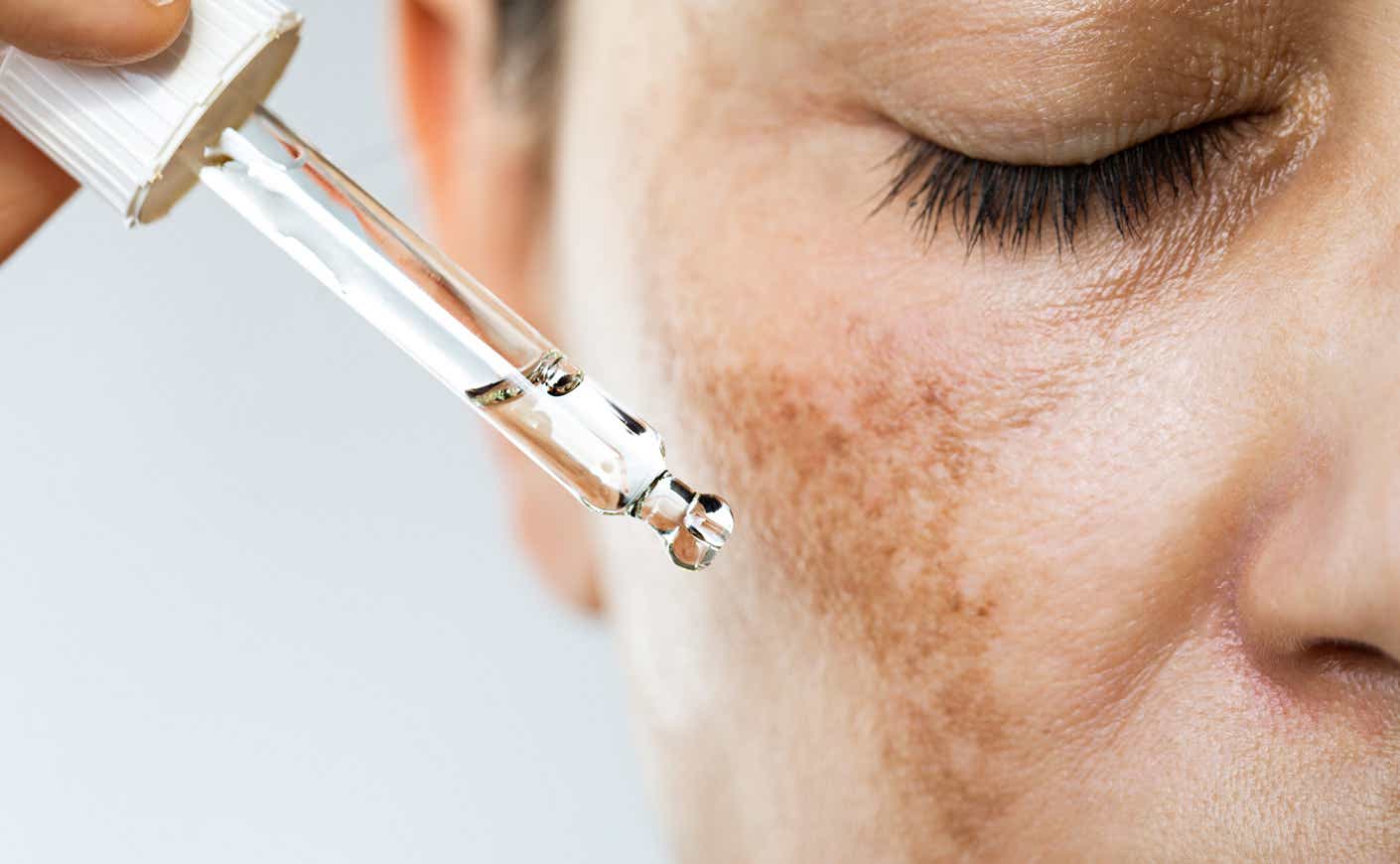 a woman with a dropper near her face