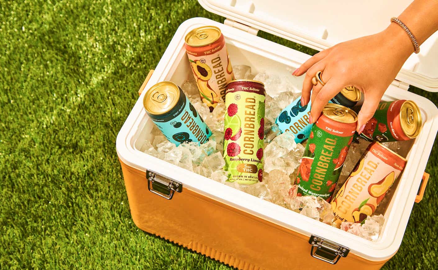 cooler of drinks with hand reaching in