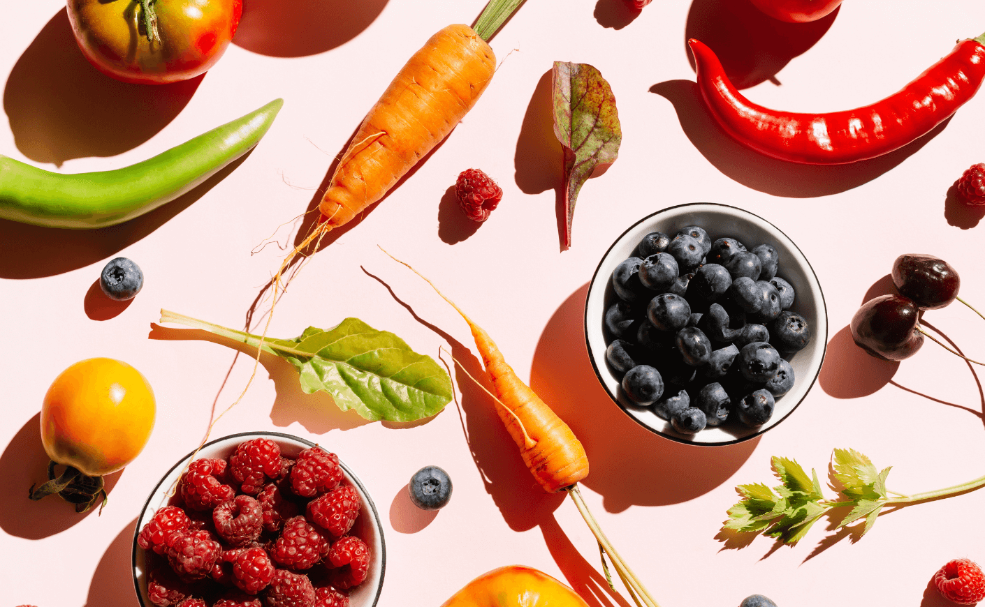 fruits and vegetables on a pink background