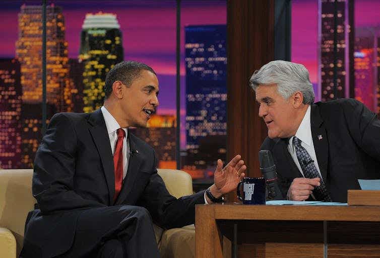 Two men on a TV set talking.