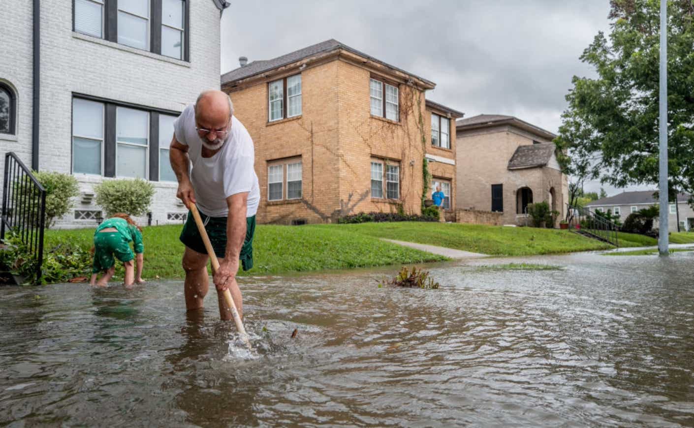A man trying to keep flood waters at bay.