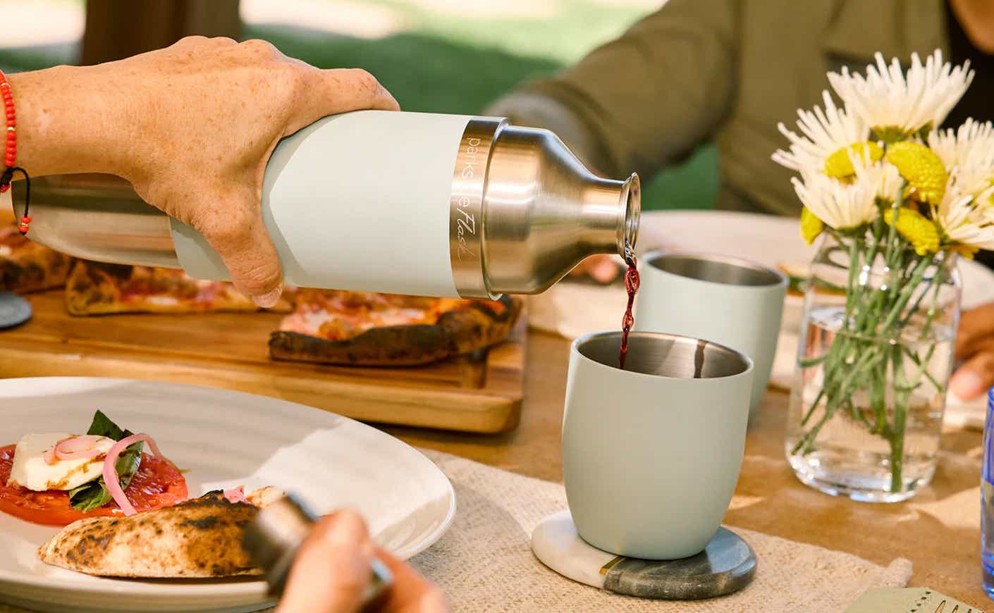 high camp flask poured at picnic table