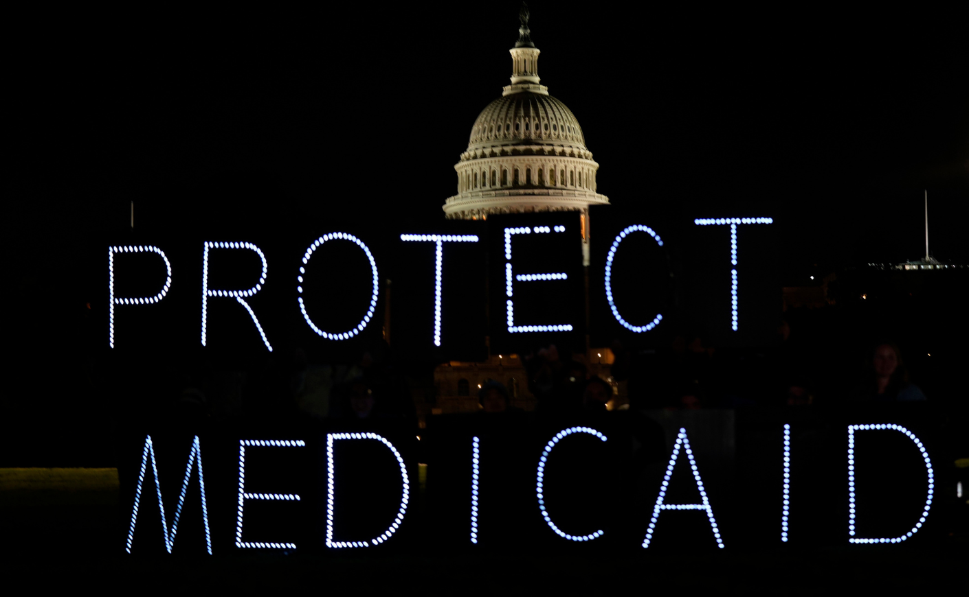 Lights spelling out PROTECT MEDICAID in front of the U.S. Capitol