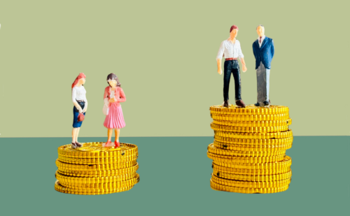 Two female dolls standing on top of a stack of coins next to two male dolls standing on a taller stack of coins