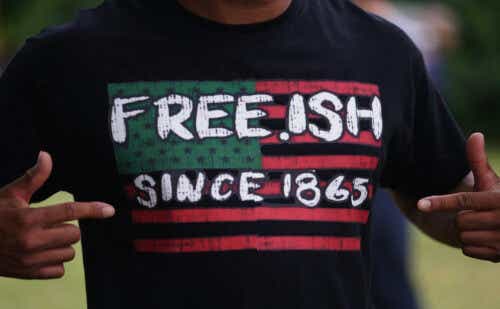 A man displays a shirt celebrating the freedom of enslaved Black people during the Juneteenth celebration in the Greenwood District on June 19, 2020 in Tulsa, Oklahoma