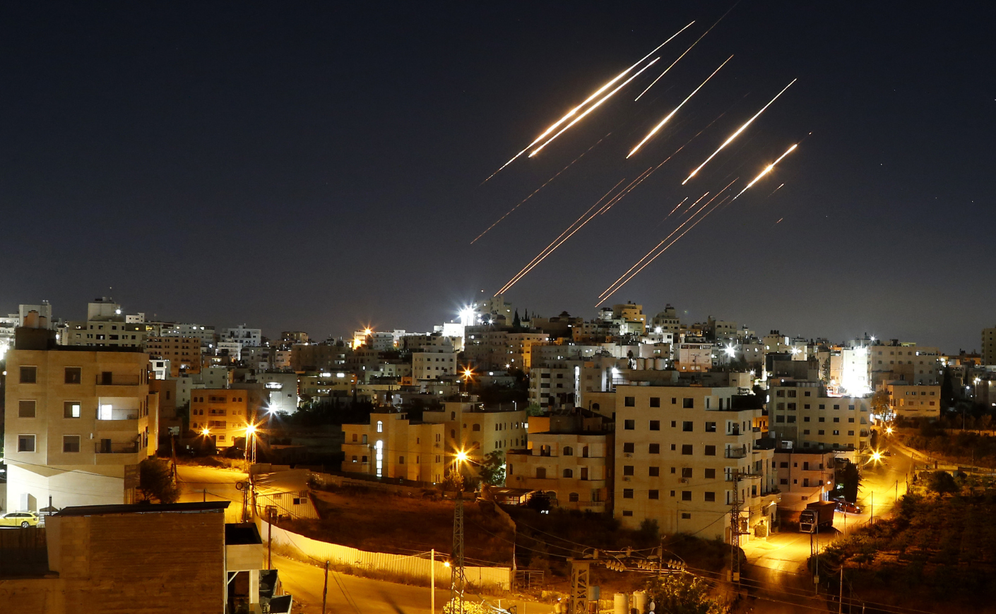 Streaks of light from Iranian ballistic missiles are seen in the night sky above Hebron, West Bank, as Iran resumes its retaliatory strikes against Israel.