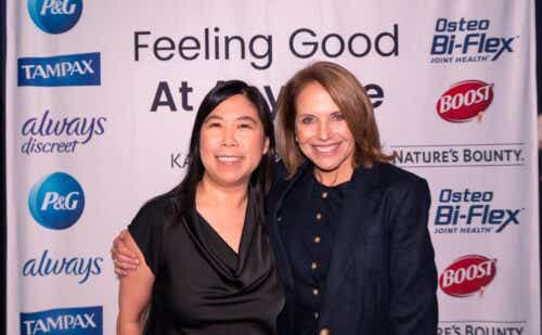 Dr. Karen Tang and Katie Couric pose in front of P&G step and repeat