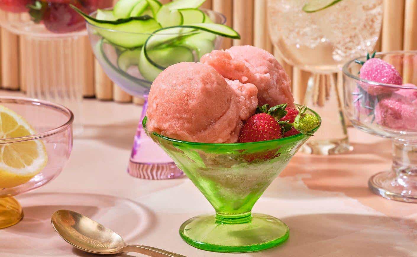 Homemade strawberry cucumber sorbet in a bowl with fresh fruit.