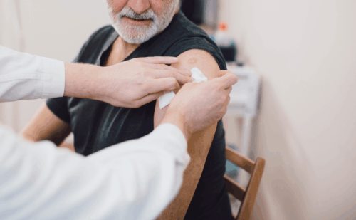 older man getting vaccine shot
