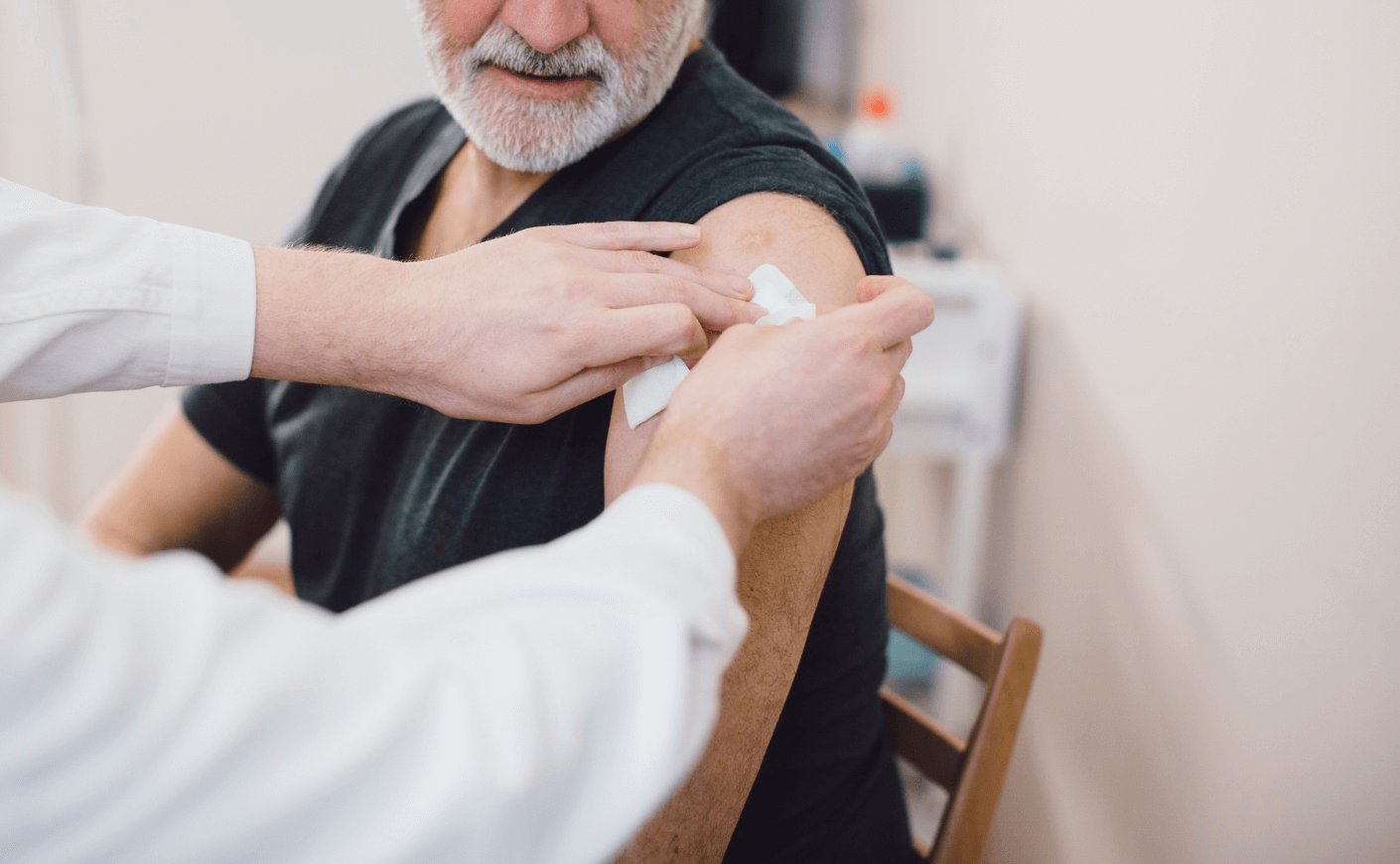 older man getting vaccine shot