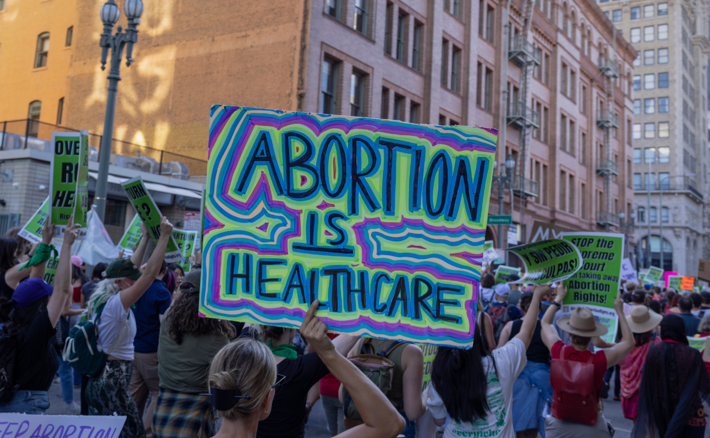 A protestor holding a sign reading "Abortion is healthcare"
