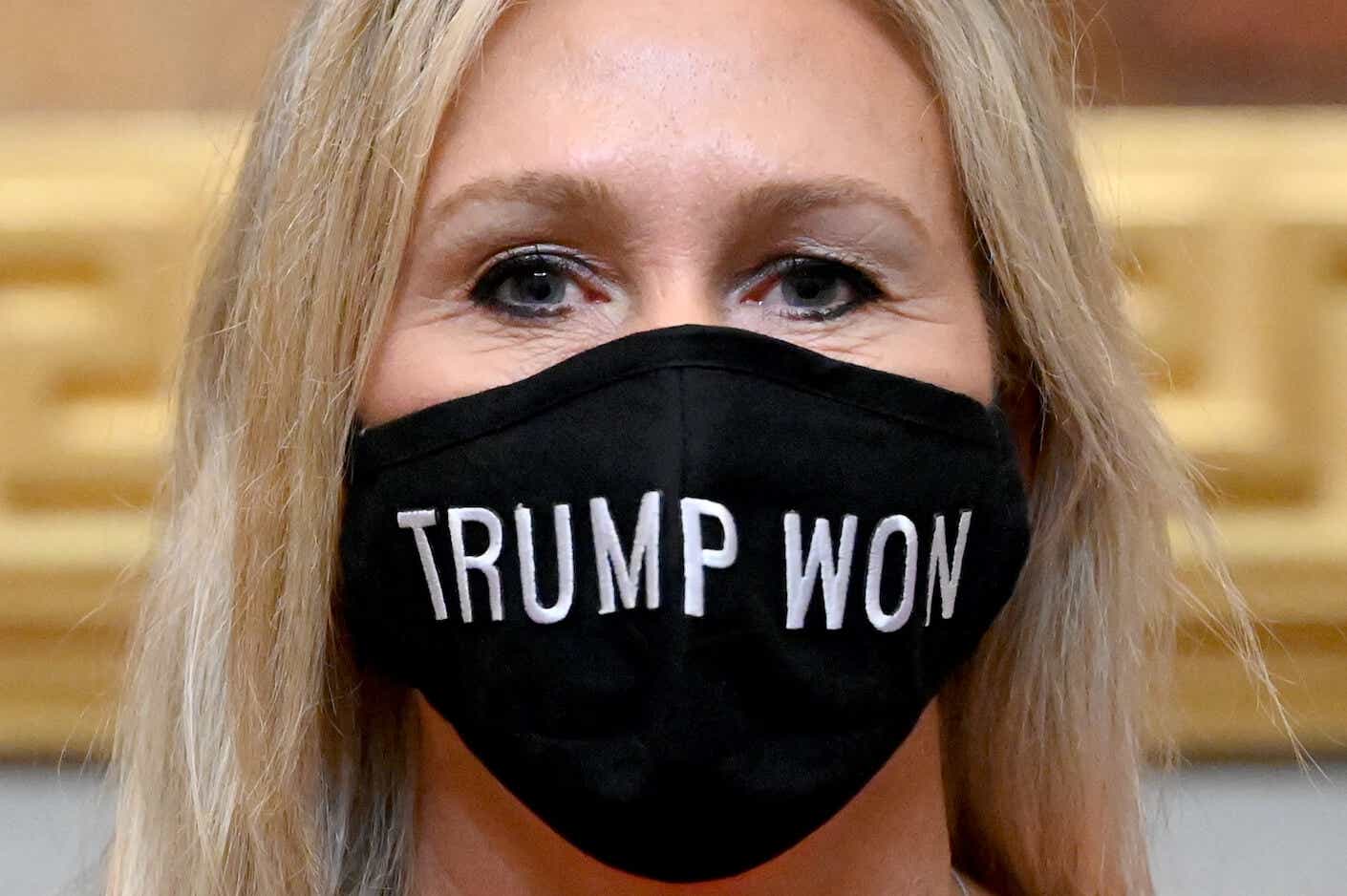 marjorie taylor greene wearing a "trump won" mask