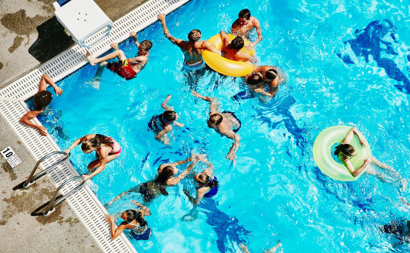 Group of friends playing together in outdoor pool
