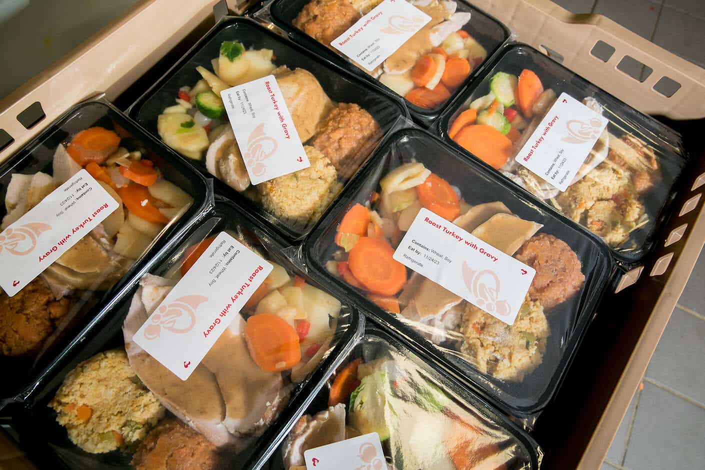 a crate full of packaged and labeled meals