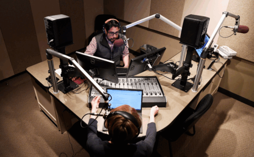A man and a woman doing a radio show
