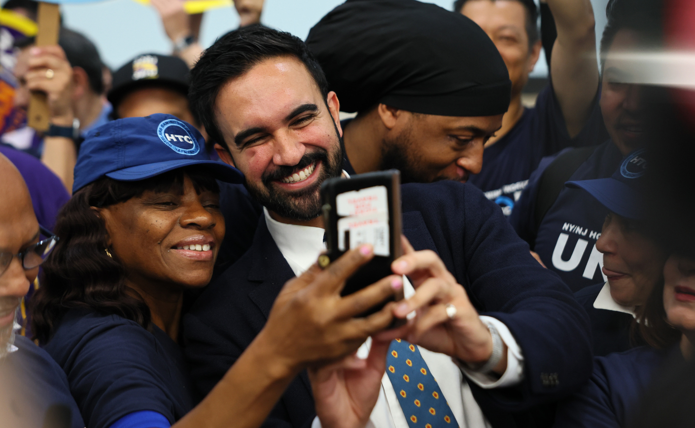 Zohran Mamdani takes pictures with supporters
