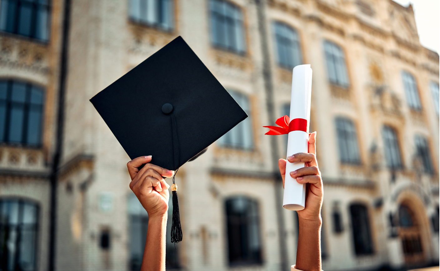 a person holds a cap and diploma