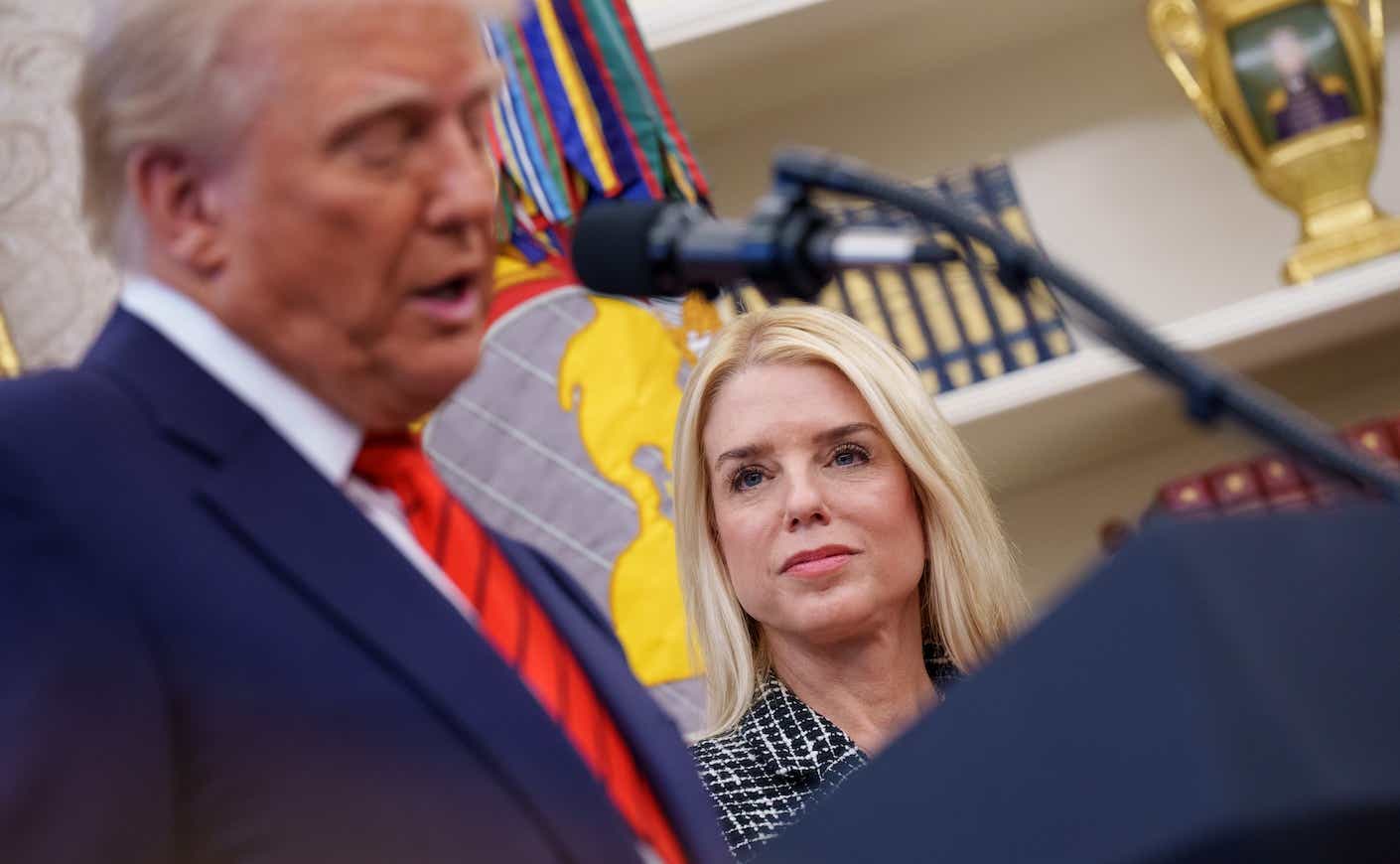 pam bondi looking at donald trump as he speaks