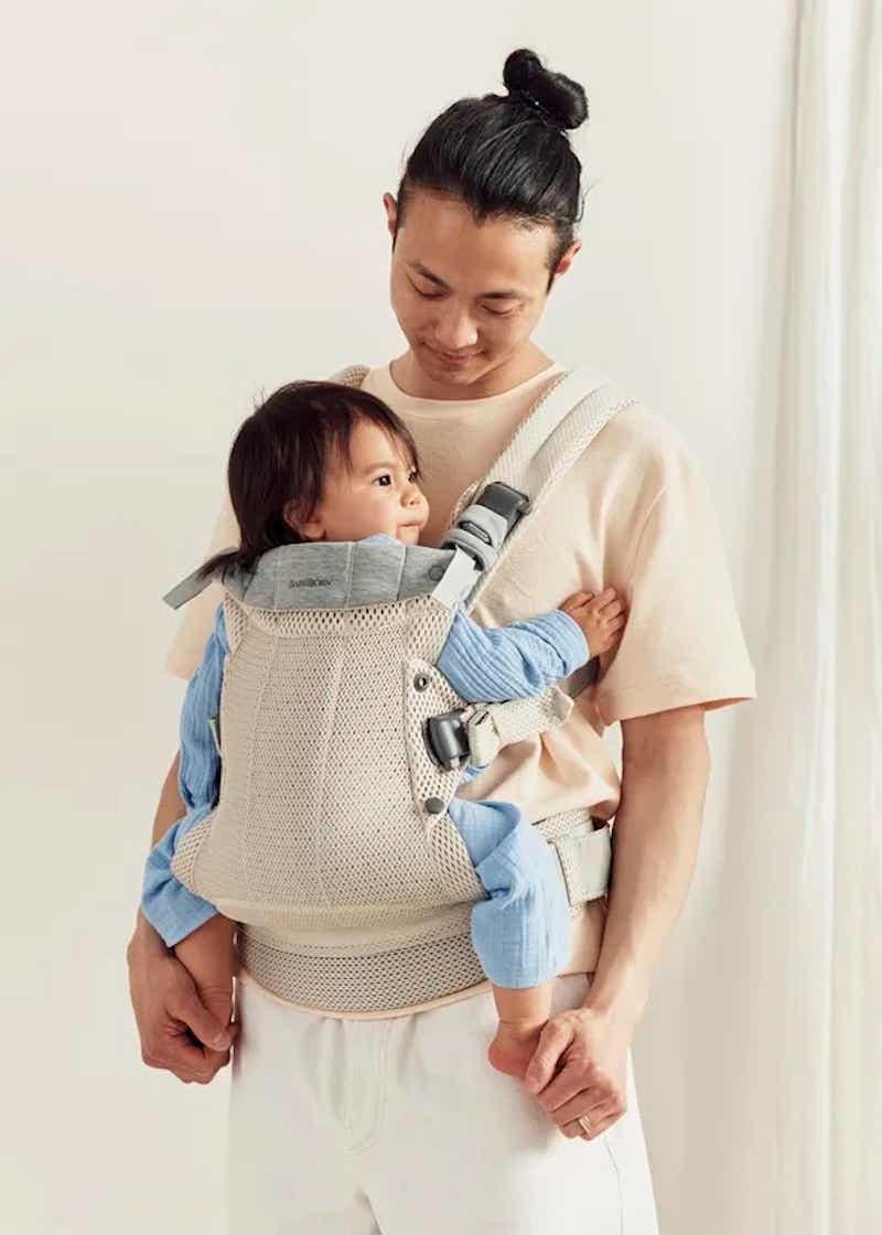 man with baby in carrier on his front