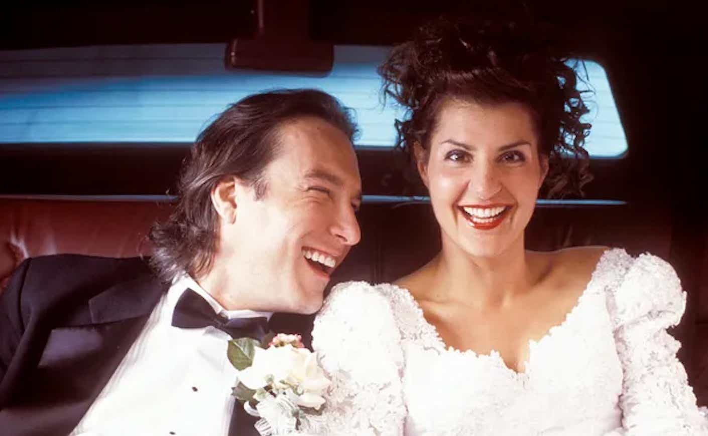 john corbette looking at nia vardalos in the back seat of a car in my big fat greek wedding