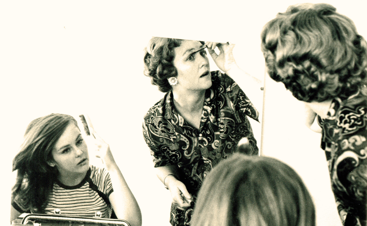 woman and her daughter applying makeup