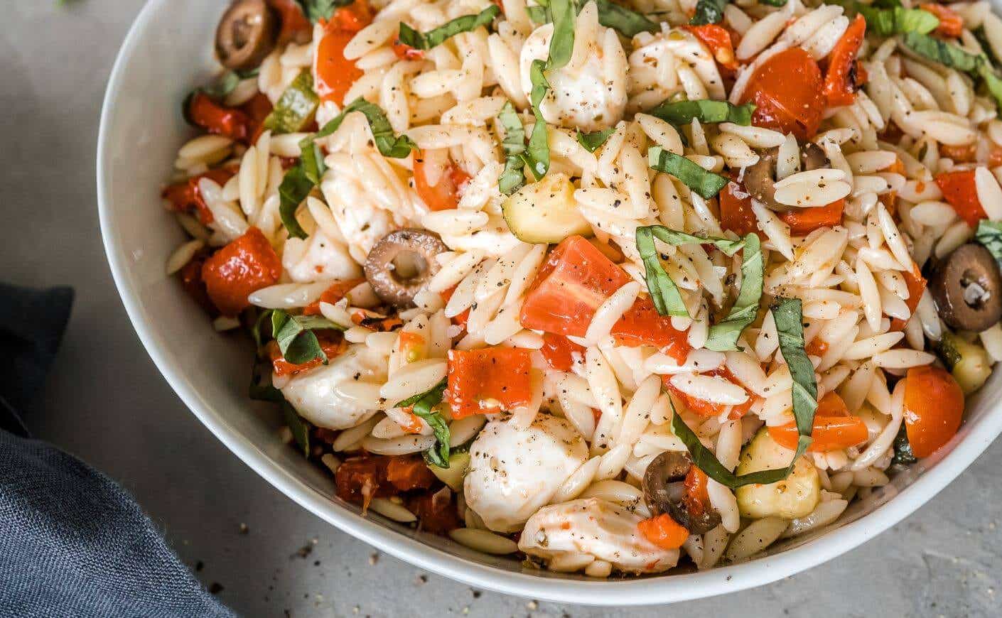 A bowl of orzo pasta salad.