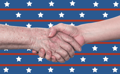 Two wrinkled hands in a handshake over a stars-and-stripes background