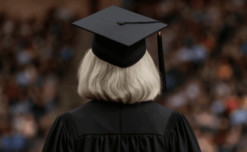 woman with gray hair graduating college