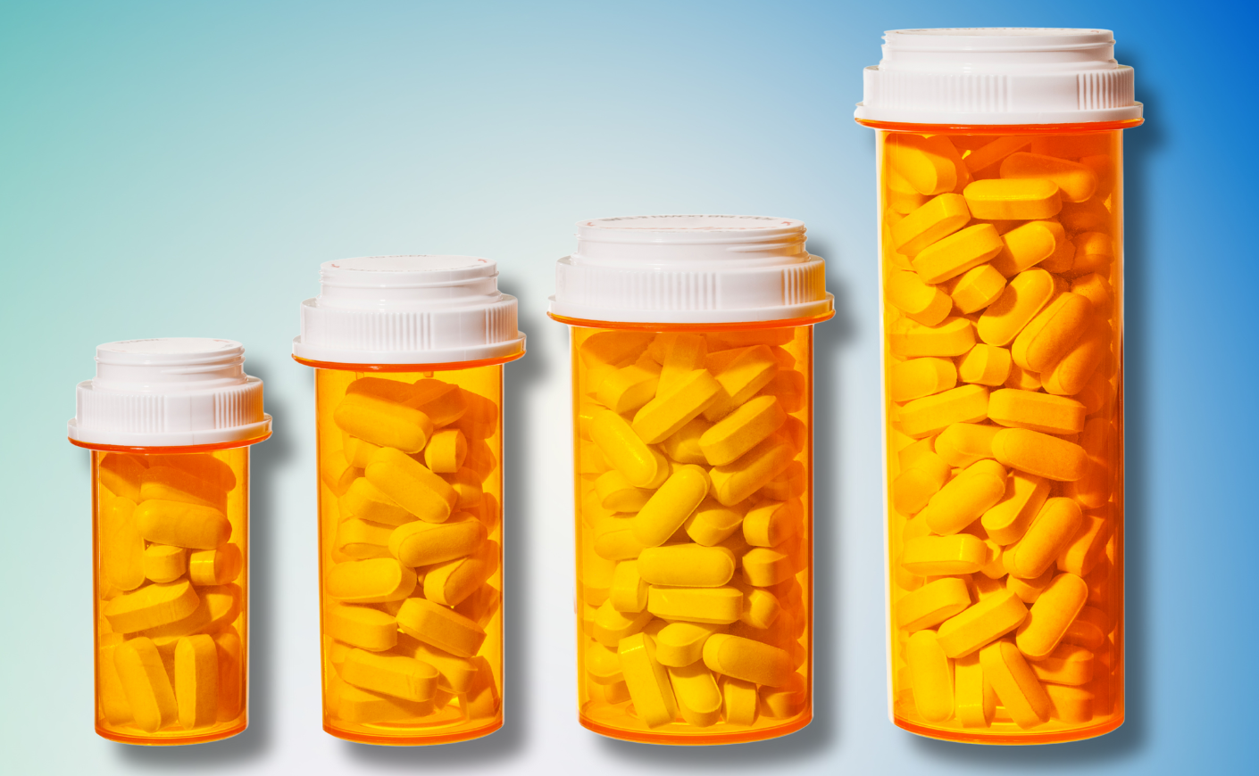 Bottles of pills arranged to represent a bar graph showing the rising cost of medicine and health care.
