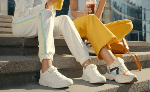 two people sitting on a step wearing sweatpants