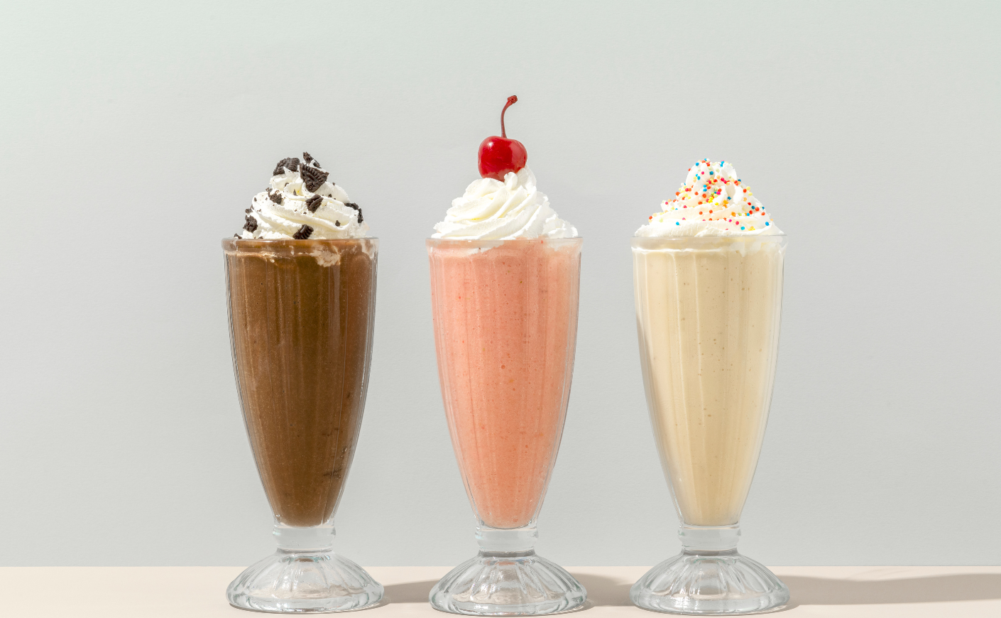 a chocolate, strawberry, and vanilla milkshake