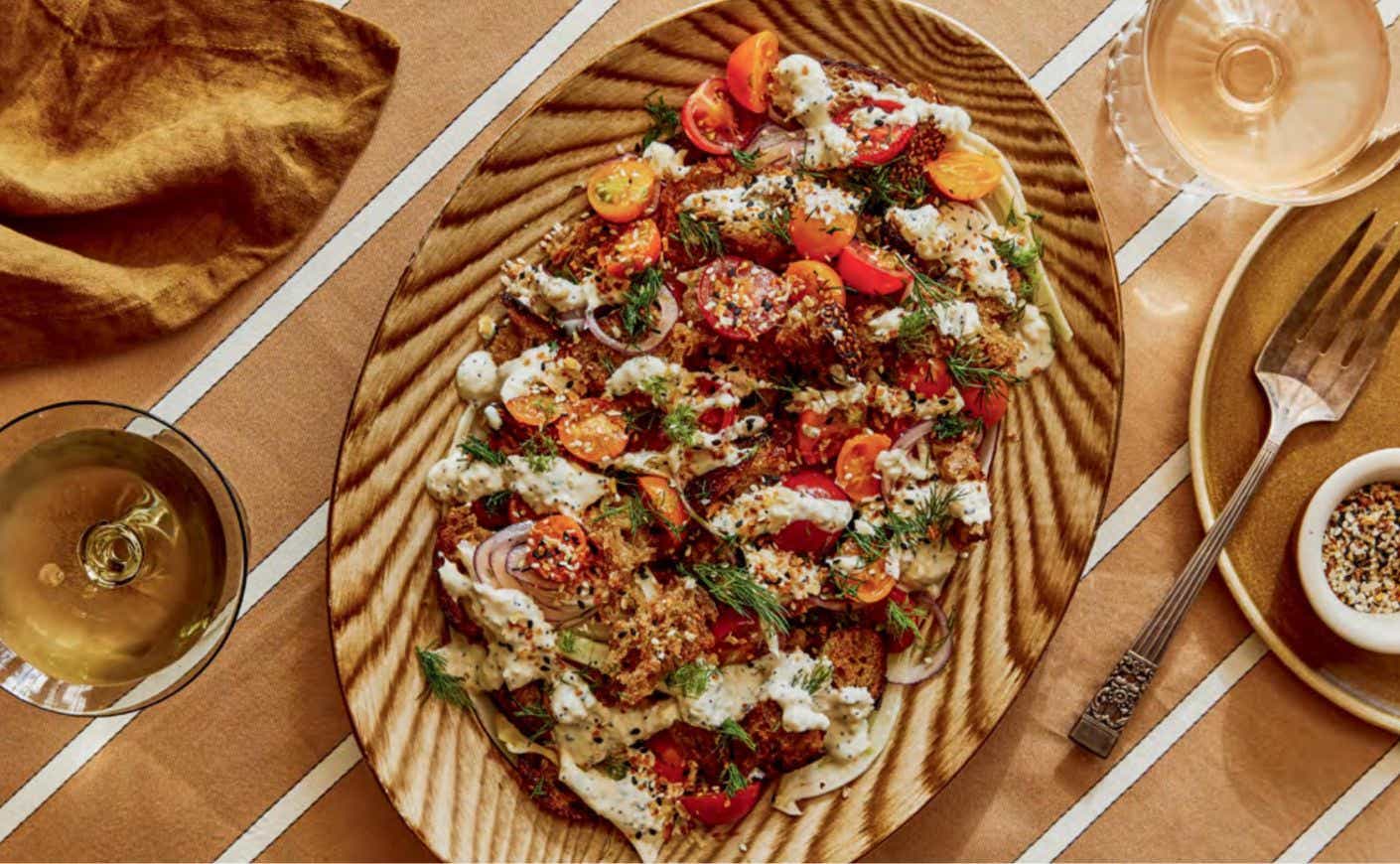 A panzanella salad on a wooden platter.