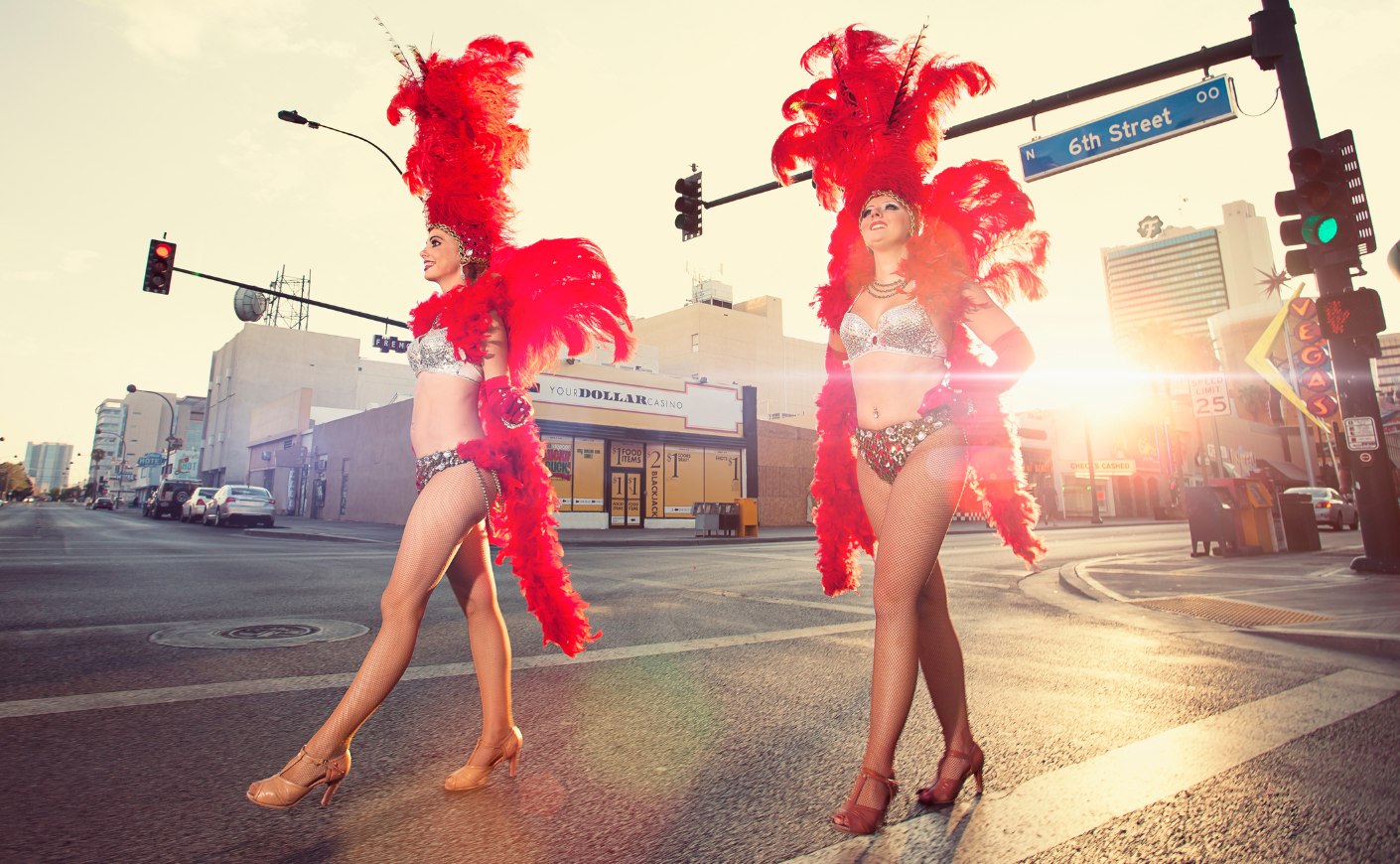 Las Vegas showgirls in red feather headdresses and sparkly bikinis strutting down the streets of Las Vegas