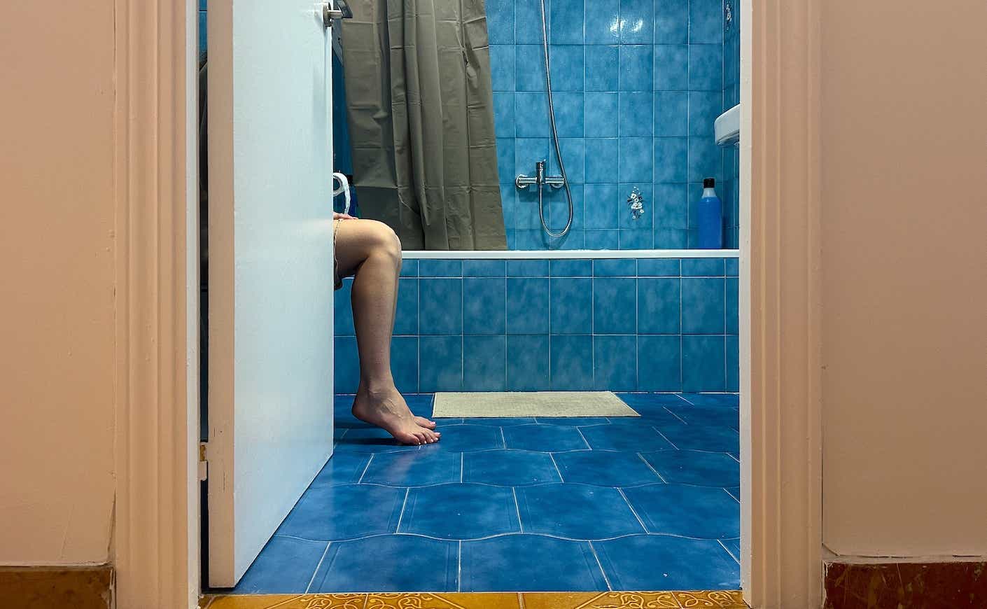 woman in a bathroom on the toilet