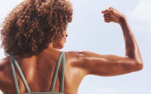 Back of woman flexing bicep