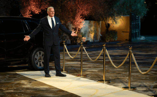 Mel Owens in a tux stands outside the Bachelor mansion
