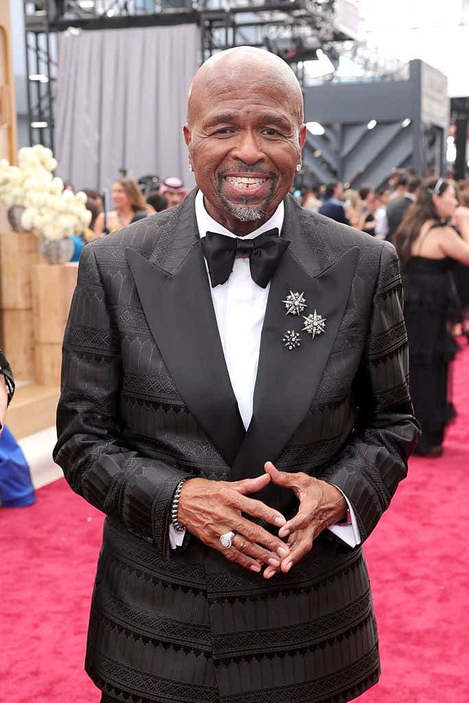 William Stanford Davis arrives at the Emmys red carpet wearing a textured black tux and three silver pins