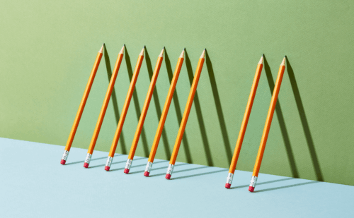 pencils leaning against a wall