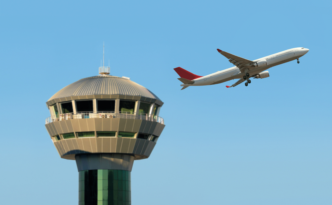 Plane flying past an air traffic control tower