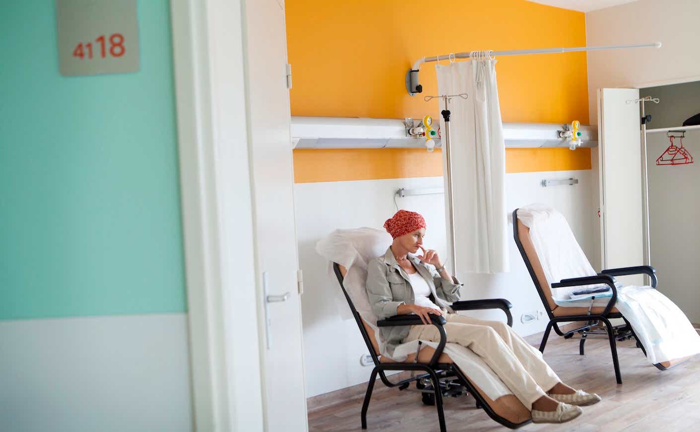 Woman in hospital room receiving chemotherapy