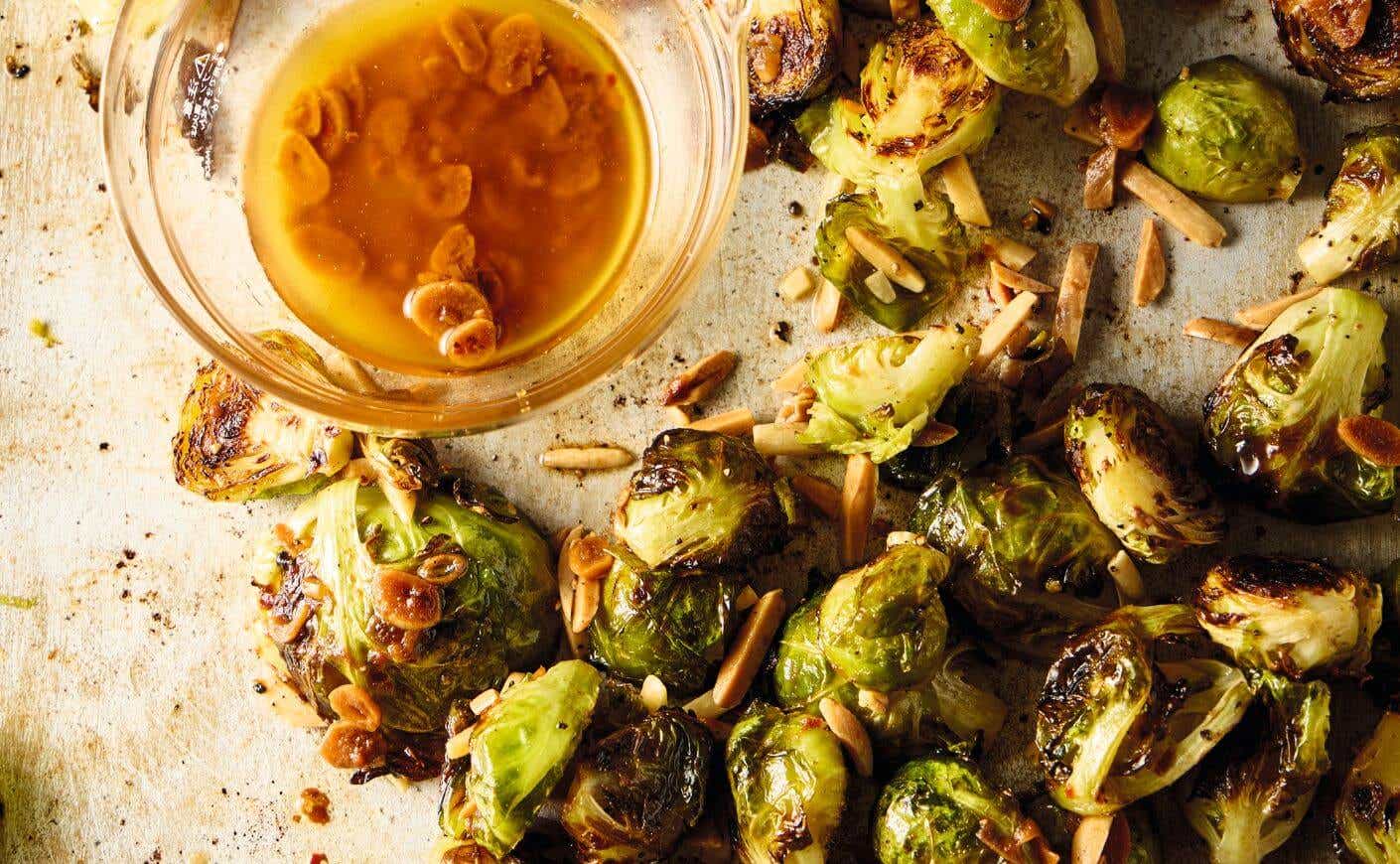 A tray of roasted Brussels sprouts and a ramekin of bagna cauda.