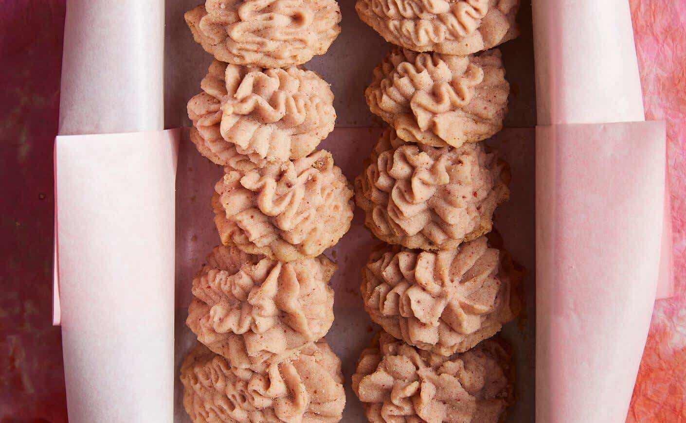 Two rows of pink butter flower cookies.