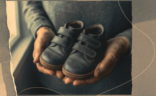 senior citizen holding children's shoes