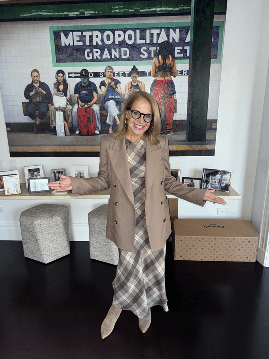 Katie Couric wears a bias dress and blazer.