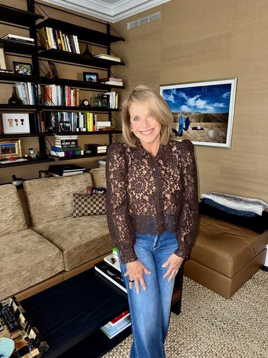 Katie Couric wears a brown lace top and jeans.
